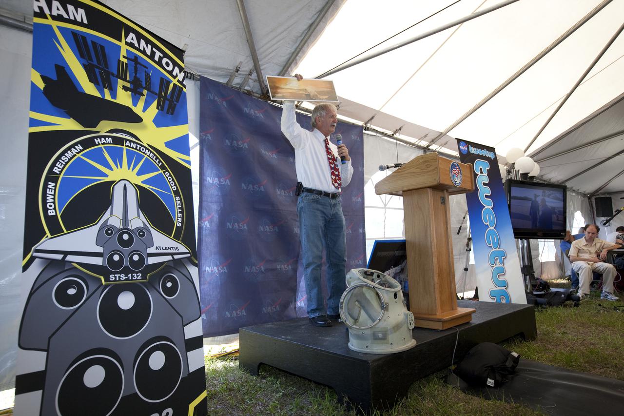 CAPE CANAVERAL, Fla. - At NASA's Kennedy Space Center in Florida, NASA's Ron Woods, a flight crew equipment specialist, presents one of his space-themed paintings to the participants in NASA's STS-132 Tweetup.  NASA is hosting 150 people from around the world and providing them with a behind-the-scenes perspective to share with their followers via the social networking service Twitter.  Attendees were randomly selected from more than 1,000 online registrations and include people from more than 30 states, the District of Columbia, Puerto Rico, the Netherlands, New Zealand and England. The Tweeters are being given the chance to meet with shuttle technicians, managers, engineers and astronauts, to take a tour of Kennedy, and to experience the exhilaration of the launch of space shuttle Atlantis' STS-132 mission.  A tent was set up especially for the occasion near the countdown clock at Kennedy's Press Site.  Atlantis' liftoff is set for 2:20 p.m. EDT on May 14.  STS-132 is the 34th mission to the station and the last scheduled flight for Atlantis. For more information on the STS-132 mission objectives, payload and crew, visit http:__www.nasa.gov_mission_pages_shuttle_shuttlemissions_sts132_index.html. Photo Credit: NASA_Amanda Diller