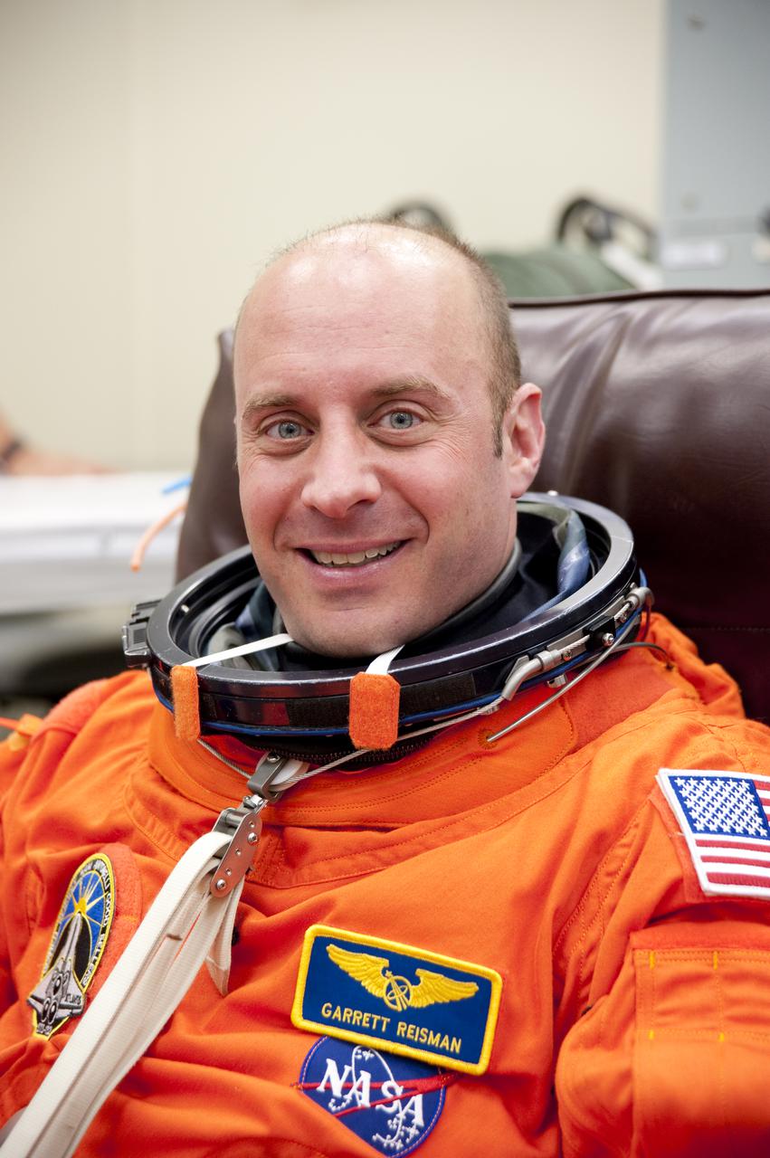 CAPE CANAVERAL, Fla. - In the Operations and Checkout Building at NASA's Kennedy Space Center in Florida, the astronauts of space shuttle Atlantis' STS-132 crew put on their launch-and-entry suits before heading to the Astrovan for the ride to Launch Pad 39A. Mission Specialist Garrett Reisman, seen here, was a flight engineer on the International Space Station's Expedition 16 and 17.  Liftoff of the STS-132 mission is set for 2:20 p.m. EDT on May 14.  The six-member STS-132 crew will deliver the Russian-built Mini Research Module-1 to the International Space Station.  Named Rassvet, Russian for 'dawn,' the module is the second in a series of new pressurized components for Russia and will be permanently attached to the Earth-facing port of the Zarya control module.  Rassvet will be used for cargo storage and will provide an additional docking port to the station. Also aboard Atlantis is an Integrated Cargo Carrier, or ICC, an unpressurized flat bed pallet and keel yoke assembly used to support the transfer of exterior cargo from the shuttle to the station.  STS-132 is the 34th mission to the station and the last scheduled flight for Atlantis. For more information on the STS-132 mission objectives, payload and crew, visit http:__www.nasa.gov_mission_pages_shuttle_shuttlemissions_sts132_index.html. Photo Credit: NASA_Kim Shiflett