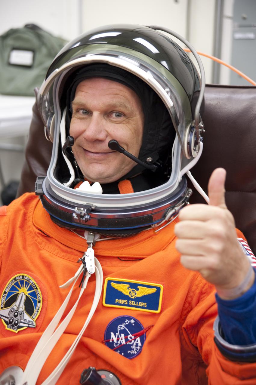 CAPE CANAVERAL, Fla. - In the Operations and Checkout Building at NASA's Kennedy Space Center in Florida, the astronauts of space shuttle Atlantis' STS-132 crew put on their launch-and-entry suits before heading to the Astrovan for the ride to Launch Pad 39A. Mission Specialist Piers Sellers, seen here checking out his helmet, is making his third spaceflight.  Liftoff of the STS-132 mission is set for 2:20 p.m. EDT on May 14.  The six-member STS-132 crew will deliver the Russian-built Mini Research Module-1 to the International Space Station.  Named Rassvet, Russian for 'dawn,' the module is the second in a series of new pressurized components for Russia and will be permanently attached to the Earth-facing port of the Zarya control module.  Rassvet will be used for cargo storage and will provide an additional docking port to the station. Also aboard Atlantis is an Integrated Cargo Carrier, or ICC, an unpressurized flat bed pallet and keel yoke assembly used to support the transfer of exterior cargo from the shuttle to the station.  STS-132 is the 34th mission to the station and the last scheduled flight for Atlantis. For more information on the STS-132 mission objectives, payload and crew, visit http:__www.nasa.gov_mission_pages_shuttle_shuttlemissions_sts132_index.html. Photo Credit: NASA_Kim Shiflett