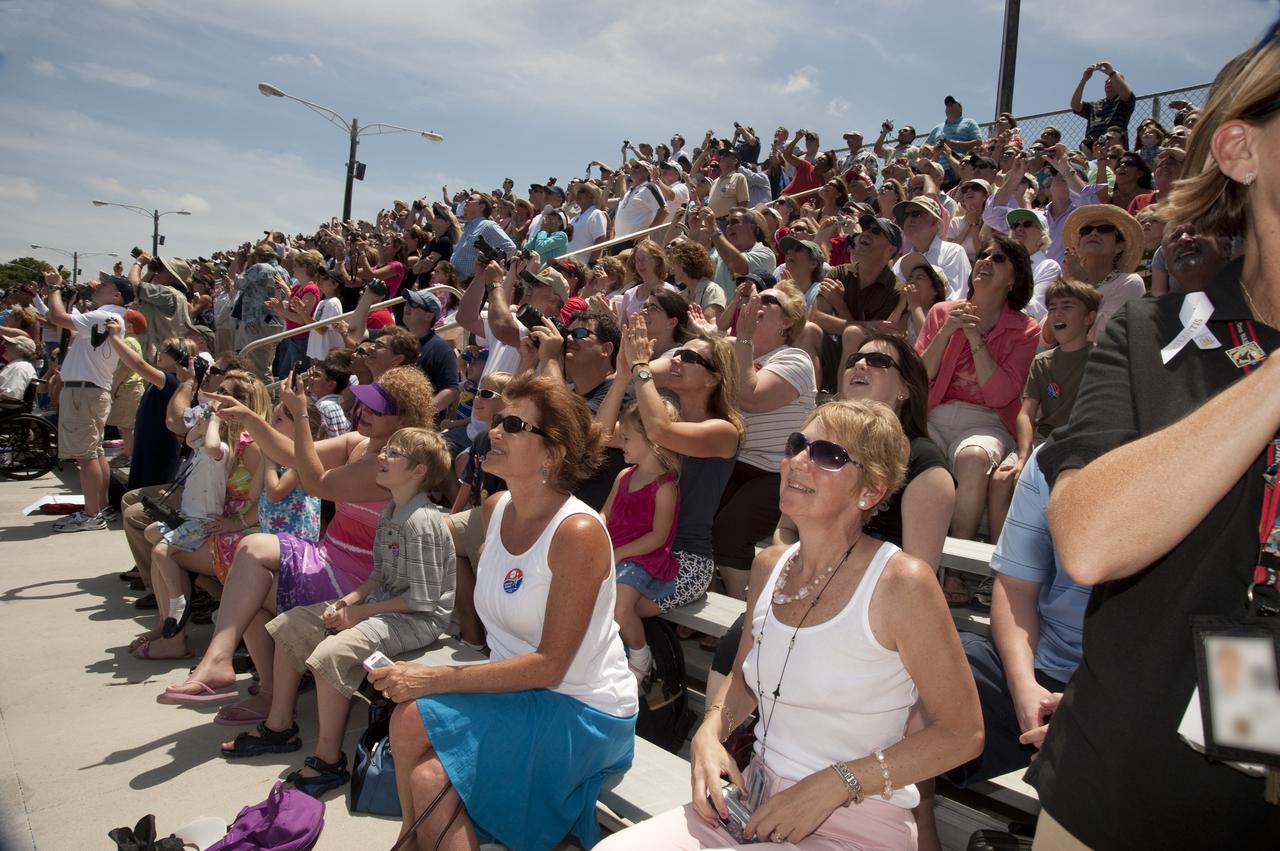 CAPE CANAVERAL, Fla. - Children and adults at the Banana Creek Viewing Site near the Saturn V Center at NASA's Kennedy Space Center in Florida snap photos, applaud and cheer as space shuttle Atlantis lifts off Launch Pad 39A. Launch of the STS-132 mission to the International Space Station occurred right on time at 2:20 p.m. on May 14.   The Russian-built Mini Research Module-1 known as Rassvet, or 'dawn,' is inside the shuttle's cargo bay. It will provide additional storage space and a new docking port for Russian Soyuz and Progress spacecraft. The laboratory will be attached to the bottom port of the station's Zarya module. The mission's three spacewalks will focus on storing spare components outside the station, including six batteries, a communications antenna and parts for the Canadian Dextre robotic arm. STS-132 is the 132nd shuttle flight, the 32nd for Atlantis and the 34th shuttle mission dedicated to station assembly and maintenance. For more information on the STS-132 mission objectives, payload and crew, visit www.nasa.gov_mission_pages_shuttle_shuttlemissions_sts132_index.html. Photo Credit: NASA_Ben Cooper