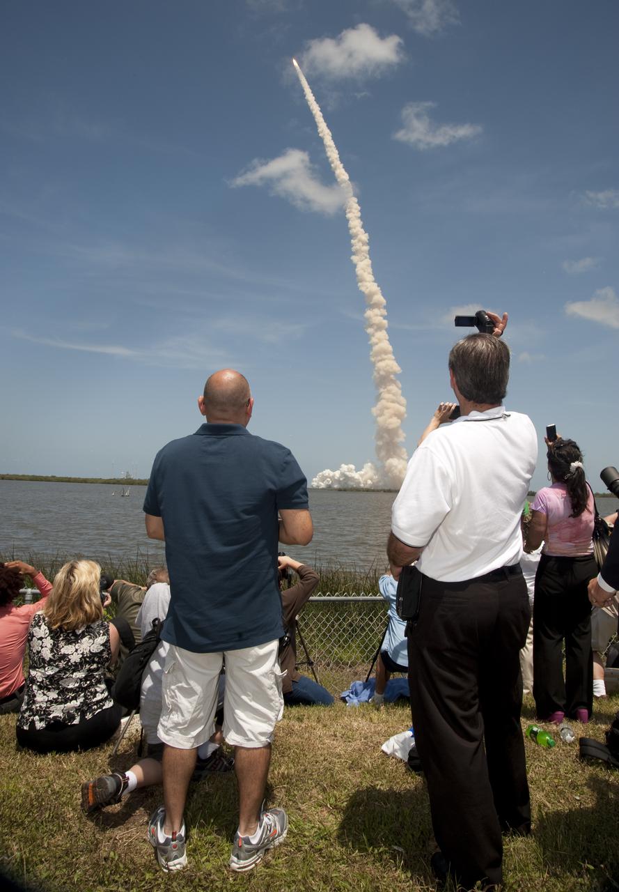 CAPE CANAVERAL, Fla. - Spectators at the Banana Creek Viewing Site near the Saturn V Center at NASA's Kennedy Space Center in Florida snap photos of space shuttle Atlantis lifting off Launch Pad 39A on the STS-132 mission to the International Space Station at 2:20 p.m. EDT on May 14. The Russian-built Mini Research Module-1 known as Rassvet, or 'dawn,' is inside the shuttle's cargo bay. It will provide additional storage space and a new docking port for Russian Soyuz and Progress spacecraft. The laboratory will be attached to the bottom port of the station's Zarya module. The mission's three spacewalks will focus on storing spare components outside the station, including six batteries, a communications antenna and parts for the Canadian Dextre robotic arm. STS-132 is the 132nd shuttle flight, the 32nd for Atlantis and the 34th shuttle mission dedicated to station assembly and maintenance. For more information on the STS-132 mission objectives, payload and crew, visit www.nasa.gov_mission_pages_shuttle_shuttlemissions_sts132_index.html. Photo Credit: NASA_Ben Cooper