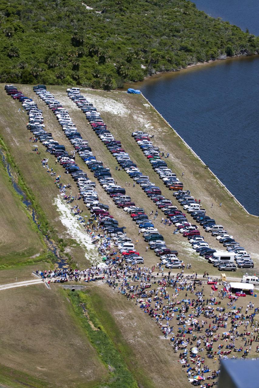 CAPE CANAVERAL, Fla. - Employees and their families gather at the Turn Basin at NASA's Kennedy Space Center in Florida to watch space shuttle Atlantis lift off from Launch Pad 39A.  Launch of the STS-132 mission to the International Space Station occurred right on time at 2:20 p.m. on May 14.  The Russian-built Mini Research Module-1 known as Rassvet, or 'dawn,' is inside the shuttle's cargo bay. It will provide additional storage space and a new docking port for Russian Soyuz and Progress spacecraft. The laboratory will be attached to the bottom port of the station's Zarya module.  The mission's three spacewalks will focus on storing spare components outside the station, including six batteries, a communications antenna and parts for the Canadian Dextre robotic arm.  STS-132 is the 132nd shuttle flight, the 32nd for Atlantis and the 34th shuttle mission dedicated to station assembly and maintenance. For more information on the STS-132 mission objectives, payload and crew, visit www.nasa.gov_mission_pages_shuttle_shuttlemissions_sts132_index.html. Photo Credit: NASA_Jack Pfaller