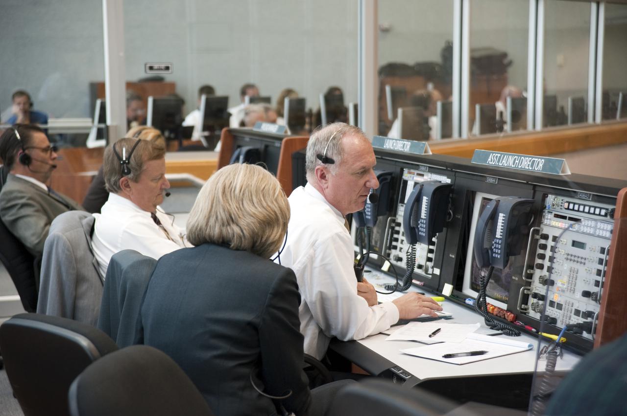 CAPE CANAVERAL, Fla. -- In Firing Room 4 of the Launch Control Center at NASA's Kennedy Space Center in Florida, Shuttle Launch Director Mike Leinbach, Assistant Launch Director Pete Nickolenko and Atlantis Flow Director Angie Brewer keep track of the imminent launch of space shuttle Atlantis on its STS-132 mission to the International Space Station. The launch team worked very few issues during the countdown and picture-perfect weather led to an on-time launch at 2:20 p.m. EDT on May 14.  STS-132 is the 132nd shuttle flight, the 32nd for Atlantis and the 34th shuttle mission dedicated to station assembly and maintenance. For more information on the STS-132 mission objectives, payload and crew, visit www.nasa.gov_mission_pages_shuttle_shuttlemissions_sts132_index.html. Photo credit: NASA_Kim Shiflett