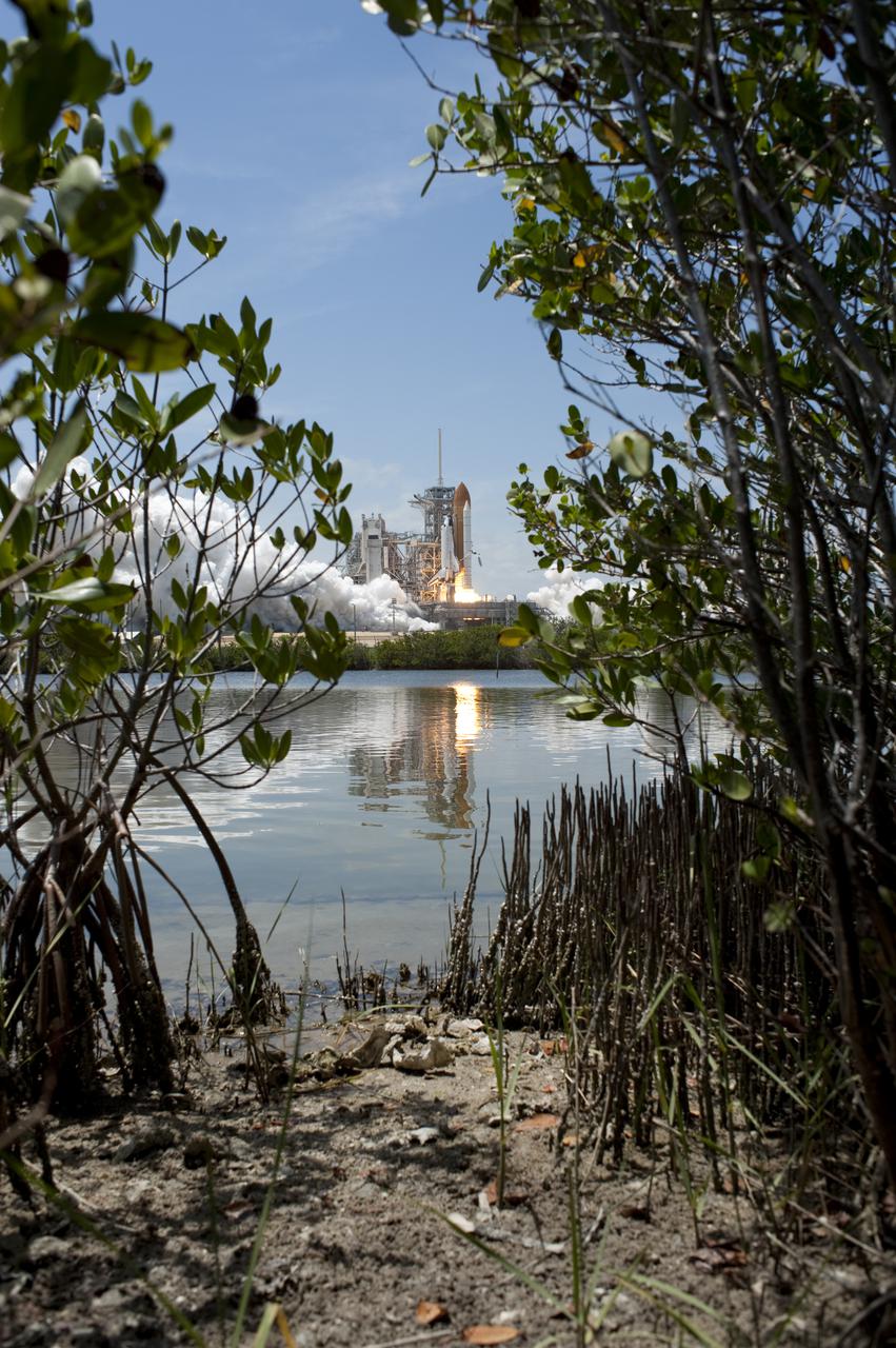 CAPE CANAVERAL, Fla. - Space shuttle Atlantis rumbles the Space Coast as it begins to lift off its pristine launch complex, which is home to the Merritt Island National Wildlife Refuge. Launch from NASA Kennedy Space Center's Launch Pad 39A occurred right on time at 2:20 p.m. EDT on May 14. Atlantis' primary payload for the STS-132 mission is the Russian-built Mini Research Module-1, which will provide additional storage space and a new docking port for Russian Soyuz and Progress spacecraft aboard the International Space Station. STS-132 is the 132nd shuttle flight, the 32nd for Atlantis and the 34th shuttle mission dedicated to station assembly and maintenance. For more information on the STS-132 mission objectives, payload and crew, visit www.nasa.gov_mission_pages_shuttle_shuttlemissions_sts132_index.html. Photo credit: NASA_Tony Gray and Tom Farrar