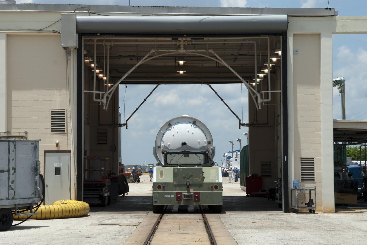 CAPE CANAVERAL, Fla. – At the Solid Rocket Booster Disassembly Facility at Hangar AF on Cape Canaveral Air Force Station in Florida, one of the solid rocket boosters used during space shuttle Atlantis' STS-132 launch, atop a tracked dolly, undergoes its first washing.  The booster was used during space shuttle Atlantis' STS-132 launch from NASA Kennedy Space Center's Launch Pad 39A on May 14. The shuttle’s two solid rocket boosters' casings and associated flight hardware are recovered from the Atlantic Ocean shortly after launch by special recovery ships, the Liberty Star and Freedom Star, and returned for refurbishment and reuse on future shuttle flights, if needed.  Hangar AF was originally used to support Project Mercury, the first U.S. human space program. Photo credit: NASA_Jim Grossmann