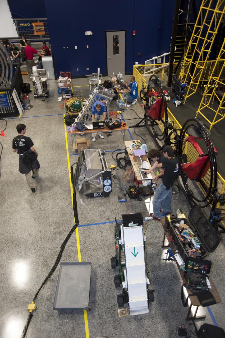 CAPE CANAVERAL, Fla. - University students tune up and tinker with their remote controlled or autonomous excavators, called lunabots, for NASA's first Lunabotics Mining Competition at the Kennedy Space Center Visitor Complex's Astronaut Hall of Fame. Twenty-two teams from around the country will maneuver their lunabots in about 60 tons of ultra-fine simulated lunar soil, called BP-1, on May 27-28. The competition is an Exploration Systems Mission Directorate project managed by Kennedy's Education Division. The purpose is to engage and retain students in science, technology, engineering and mathematics, or STEM, fields. It also provides a competitive environment that could result in innovative ideas and solutions for NASA's future excavation of the moon. Photo credit: NASA_Kim Shiflett