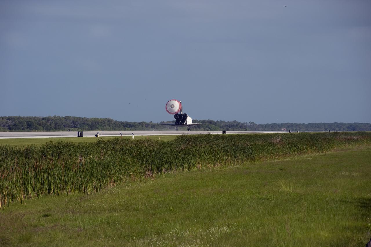CAPE CANAVERAL, Fla. - The drag chute slows space shuttle Atlantis as it rolls down Runway 33 at the Shuttle Landing Facility at NASA's Kennedy Space Center in Florida. Landing was at 8:48 a.m. EDT, completing the 12-day STS-132 mission to the International Space Station. Main gear touchdown was at 8:48:11 a.m. EDT, followed by nose gear touchdown at 8:48:21 a.m. and wheelstop at 8:49:18 a.m. On board are Commander Ken Ham, Pilot Tony Antonelli, Mission Specialists Garrett Reisman, Michael Good, Steve Bowen and Piers Sellers.   The six-member STS-132 crew carried the Russian-built Mini Research Module-1 to the International Space Station. STS-132 is the 34th shuttle mission to the station, the 132nd shuttle mission overall and the last planned flight for Atlantis. For information on the STS-132 mission and crew, visit www.nasa.gov_mission_pages_shuttle_shuttlemissions_sts132_index.html. Photo credit: NASA_Ben Cooper
