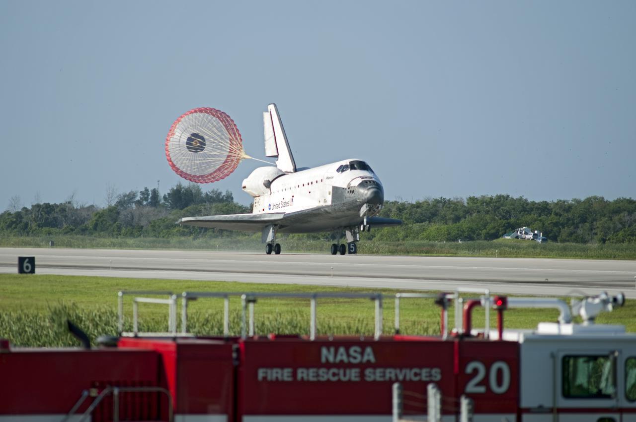 CAPE CANAVERAL, Fla. - NASA's Fire Rescue Services vehicle, part of the long convoy that meets a space shuttle upon its return from space, stands by as Atlantis rolls to a stop on Runway 33 at the Shuttle Landing Facility at NASA's Kennedy Space Center in Florida. Landing was at 8:48 a.m. EDT, completing the 12-day STS-132 mission to the International Space Station. The six-member STS-132 crew carried the Russian-built Mini Research Module-1 to the International Space Station. STS-132 is the 34th shuttle mission to the station, the 132nd shuttle mission overall and the last planned flight for Atlantis. For information on the STS-132 mission and crew, visit www.nasa.gov_mission_pages_shuttle_shuttlemissions_sts132_index.html. Photo credit: NASA_Tony Gray