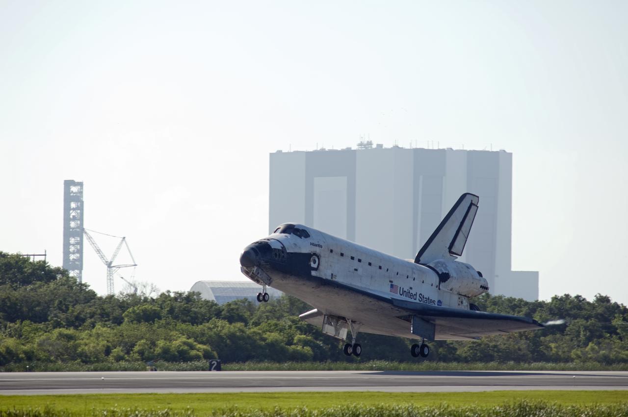 CAPE CANAVERAL, Fla. - Space shuttle Atlantis whooshes past the Vehicle Assembly Building and NASA's new mobile launcher as it nears touchdown on Runway 33 at Kennedy Space Center's Shuttle Landing Facility in Florida. Landing was at 8:48 a.m. EDT, completing the 12-day STS-132 mission to the International Space Station. The six-member STS-132 crew carried the Russian-built Mini Research Module-1 to the International Space Station. STS-132 is the 34th shuttle mission to the station, the 132nd shuttle mission overall and the last planned flight for Atlantis. For information on the STS-132 mission and crew, visit www.nasa.gov_mission_pages_shuttle_shuttlemissions_sts132_index.html. Photo credit: NASA_Rick Wetherington