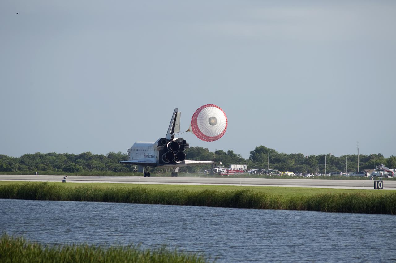 CAPE CANAVERAL, Fla. - Space shuttle Atlantis' drag chute slows the vehicle as it rolls to a stop on Runway 33 at the Shuttle Landing Facility at NASA's Kennedy Space Center in Florida. At right is the long convoy of rescue and safing vehicles that greet a space shuttle after landing. Landing was at 8:48 a.m. EDT, completing the 12-day STS-132 mission to the International Space Station. The six-member STS-132 crew carried the Russian-built Mini Research Module-1 to the International Space Station. STS-132 is the 34th shuttle mission to the station, the 132nd shuttle mission overall and the last planned flight for Atlantis. For information on the STS-132 mission and crew, visit www.nasa.gov_mission_pages_shuttle_shuttlemissions_sts132_index.html. Photo credit: NASA_Rick Wetherington
