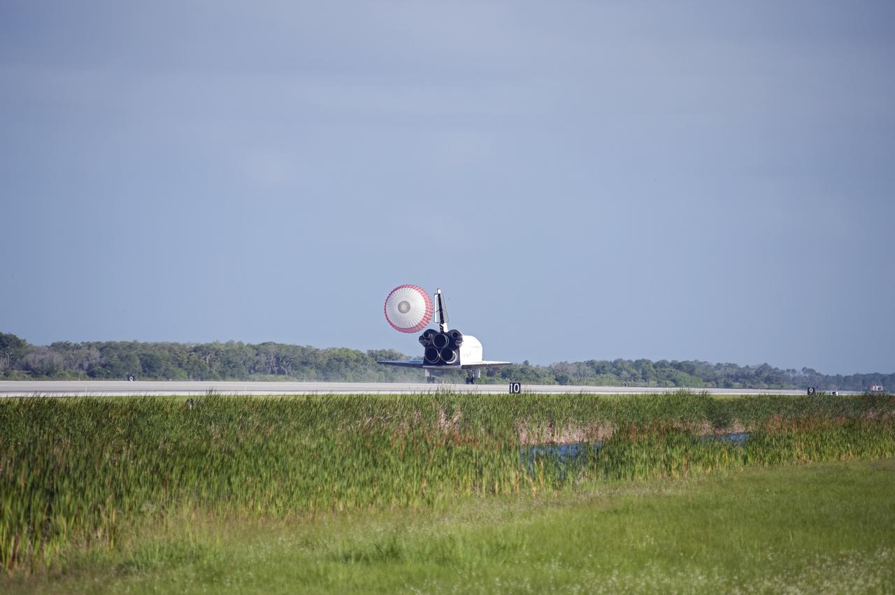 CAPE CANAVERAL, Fla. - Space shuttle Atlantis' drag chute slows the vehicle as it rolls down Runway 33 at the Shuttle Landing Facility at NASA's Kennedy Space Center in Florida. Landing was at 8:48 a.m. EDT, completing the 12-day STS-132 mission to the International Space Station.  The six-member STS-132 crew carried the Russian-built Mini Research Module-1 to the space station. STS-132 is the 34th shuttle mission to the station, the 132nd shuttle mission overall and the last planned flight for Atlantis. For information on the STS-132 mission and crew, visit www.nasa.gov_mission_pages_shuttle_shuttlemissions_sts132_index.html. Photo credit: NASA_Thomas Farrar Jr.