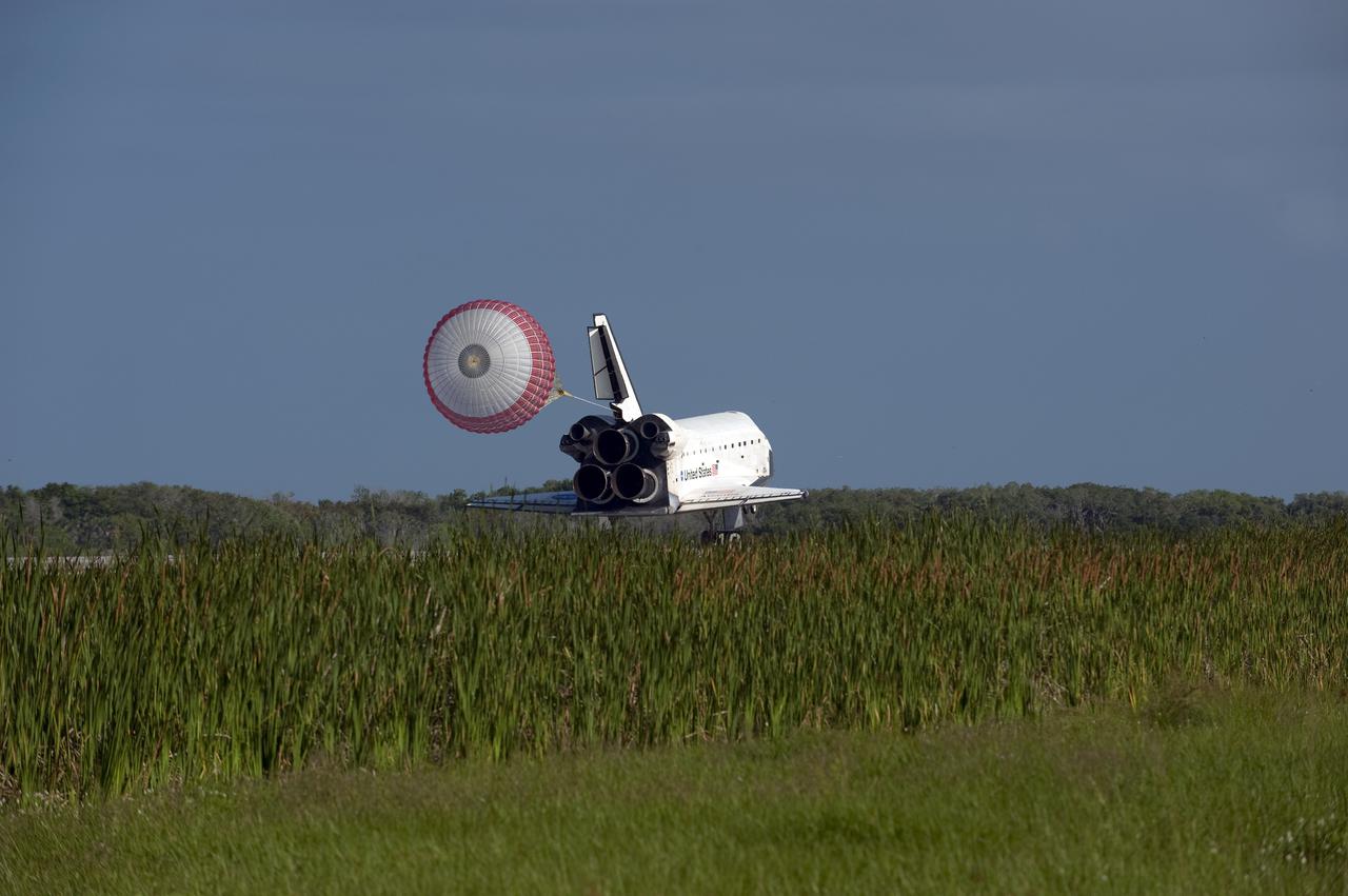CAPE CANAVERAL, Fla. - Space shuttle Atlantis' drag chute slows the vehicle as it rolls down Runway 33 at the Shuttle Landing Facility at NASA's Kennedy Space Center in Florida. The shuttle approached from the southeast in a crystal-clear blue sky, giving the Space Coast quite a show. Landing was at 8:48 a.m. EDT, completing the 12-day STS-132 mission to the International Space Station. The six-member STS-132 crew carried the Russian-built Mini Research Module-1 to the space station. STS-132 is the 34th shuttle mission to the station, the 132nd shuttle mission overall and the last planned flight for Atlantis. For information on the STS-132 mission and crew, visit www.nasa.gov_mission_pages_shuttle_shuttlemissions_sts132_index.html. Photo credit: NASA_Kevin O'Connell