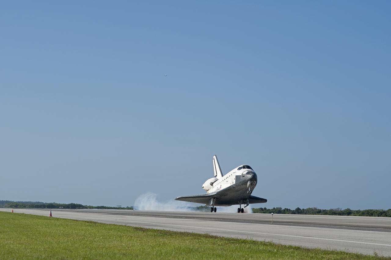 CAPE CANAVERAL, Fla. - A Shuttle Training Aircraft, or STA, top center, watches over space shuttle Atlantis as it touches down on Runway 33 at the Shuttle Landing Facility at NASA's Kennedy Space Center in Florida. The shuttle approached from the southeast in a crystal-clear blue sky, giving the Space Coast quite a show. Landing was at 8:48 a.m. EDT, completing the 12-day STS-132 mission to the International Space Station. The six-member STS-132 crew carried the Russian-built Mini Research Module-1 to the space station. STS-132 is the 34th shuttle mission to the station, the 132nd shuttle mission overall and the last planned flight for Atlantis. For information on the STS-132 mission and crew, visit www.nasa.gov_mission_pages_shuttle_shuttlemissions_sts132_index.html. Photo credit: NASA_Tony Gray and Tom Farrar
