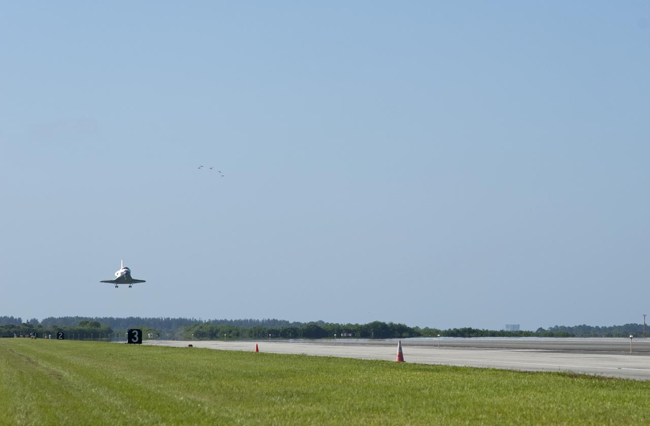CAPE CANAVERAL, Fla. - A flock of birds usher space shuttle Atlantis toward Runway 33 at the Shuttle Landing Facility at NASA's Kennedy Space Center in Florida. The shuttle approached from the southeast in a crystal-clear blue sky, giving the Space Coast quite a show. Landing was at 8:48 a.m. EDT, completing the 12-day STS-132 mission to the International Space Station. The six-member STS-132 crew carried the Russian-built Mini Research Module-1 to the space station. STS-132 is the 34th shuttle mission to the station, the 132nd shuttle mission overall and the last planned flight for Atlantis. For information on the STS-132 mission and crew, visit www.nasa.gov_mission_pages_shuttle_shuttlemissions_sts132_index.html. Photo credit: NASA_Tony Gray and Tom Farrar