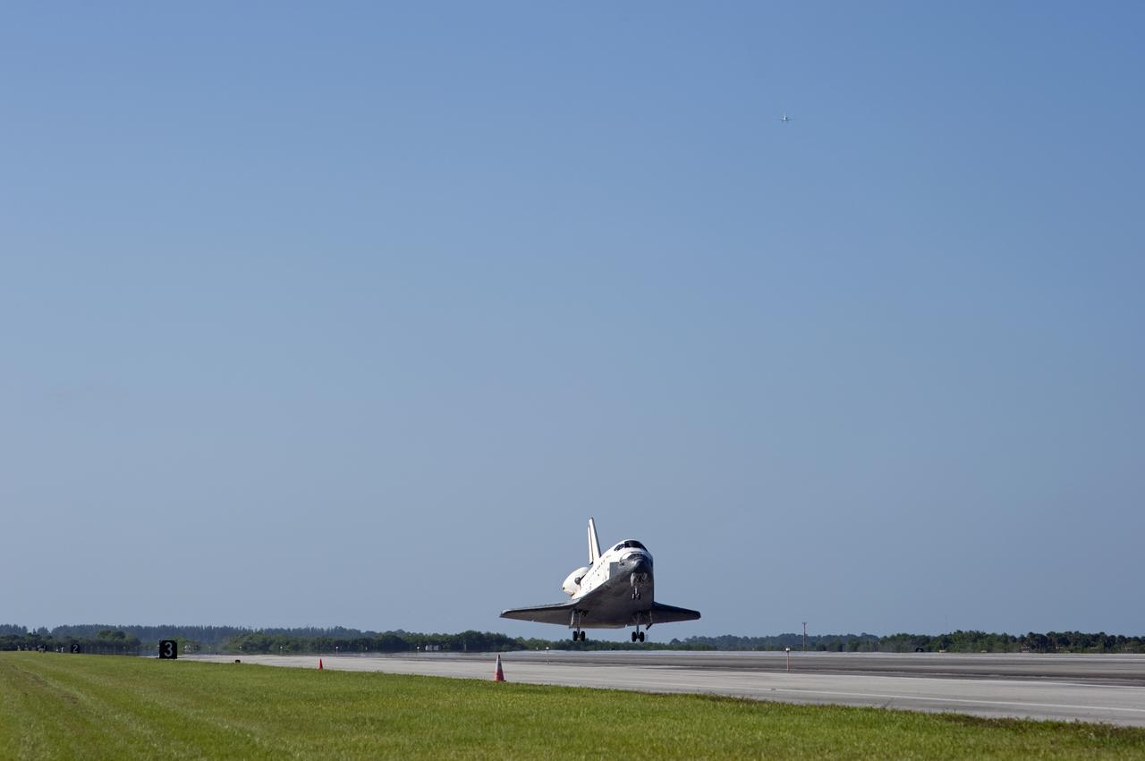 CAPE CANAVERAL, Fla. - A Shuttle Training Aircraft, or STA, top right, watches over space shuttle Atlantis as it touches down on Runway 33 at the Shuttle Landing Facility at NASA's Kennedy Space Center in Florida. The shuttle approached from the southeast in a crystal-clear blue sky, giving the Space Coast quite a show. Landing was at 8:48 a.m. EDT, completing the 12-day STS-132 mission to the International Space Station. The six-member STS-132 crew carried the Russian-built Mini Research Module-1 to the space station. STS-132 is the 34th shuttle mission to the station, the 132nd shuttle mission overall and the last planned flight for Atlantis. For information on the STS-132 mission and crew, visit www.nasa.gov_mission_pages_shuttle_shuttlemissions_sts132_index.html. Photo credit: NASA_Tony Gray and Tom Farrar