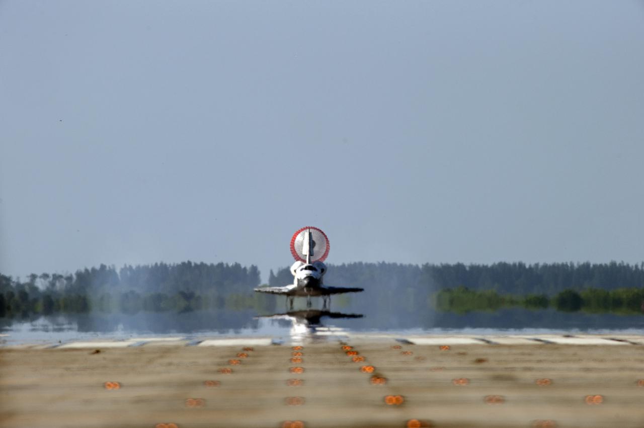 CAPE CANAVERAL, Fla. - With its drag chute unfurled, space shuttle Atlantis rolls down Runway 33 at the Shuttle Landing Facility at NASA's Kennedy Space Center in Florida. Landing was at 8:48 a.m. EDT, completing the 12-day STS-132 mission to the International Space Station.    The six-member STS-132 crew carried the Russian-built Mini Research Module-1 to the space station. STS-132 is the 34th shuttle mission to the station, the 132nd shuttle mission overall and the last planned flight for Atlantis. For information on the STS-132 mission and crew, visit www.nasa.gov_mission_pages_shuttle_shuttlemissions_sts132_index.html. Photo credit: NASA_Sandra Joseph and Carl Winebarger
