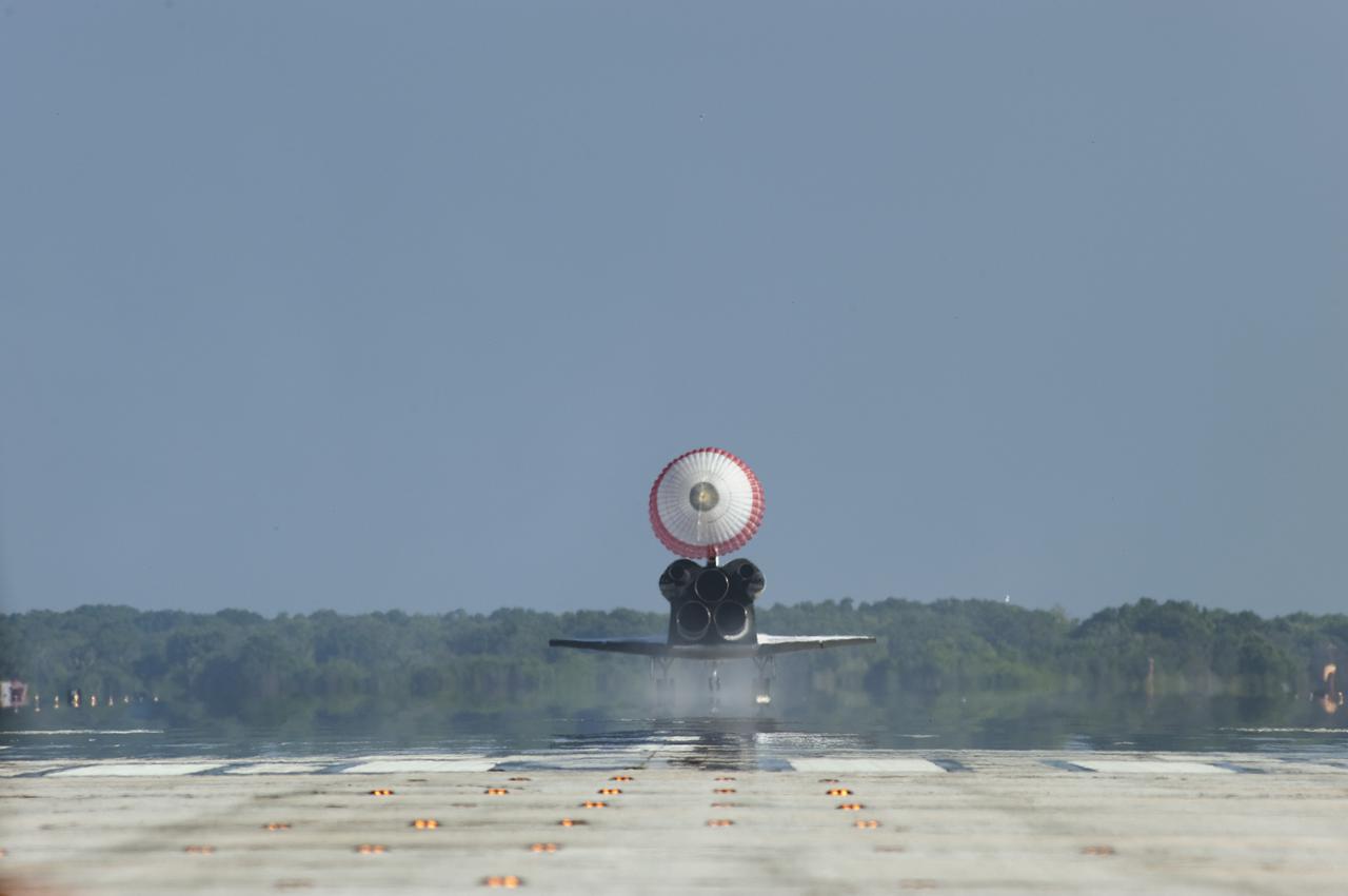 CAPE CANAVERAL, Fla. - With its drag chute unfurled, space shuttle Atlantis rolls down Runway 33 at the Shuttle Landing Facility at NASA's Kennedy Space Center in Florida. Landing was at 8:48 a.m. EDT, completing the 12-day STS-132 mission to the International Space Station.    The six-member STS-132 crew carried the Russian-built Mini Research Module-1 to the space station. STS-132 is the 34th shuttle mission to the station, the 132nd shuttle mission overall and the last planned flight for Atlantis. For information on the STS-132 mission and crew, visit www.nasa.gov_mission_pages_shuttle_shuttlemissions_sts132_index.html. Photo credit: NASA_Tony Gray and Tom Farrar