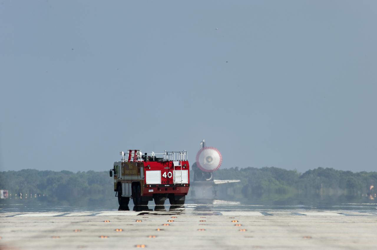 CAPE CANAVERAL, Fla. - NASA's Fire Rescue Services vehicle drives toward space shuttle Atlantis on Runway 33 at the Shuttle Landing Facility at NASA's Kennedy Space Center in Florida. Landing was at 8:48 a.m. EDT, completing the 12-day STS-132 mission to the International Space Station. The six-member STS-132 crew carried the Russian-built Mini Research Module-1 to the space station. STS-132 is the 34th shuttle mission to the station, the 132nd shuttle mission overall and the last planned flight for Atlantis. For information on the STS-132 mission and crew, visit www.nasa.gov_mission_pages_shuttle_shuttlemissions_sts132_index.html. Photo credit: NASA_Tony Gray and Tom Farrar