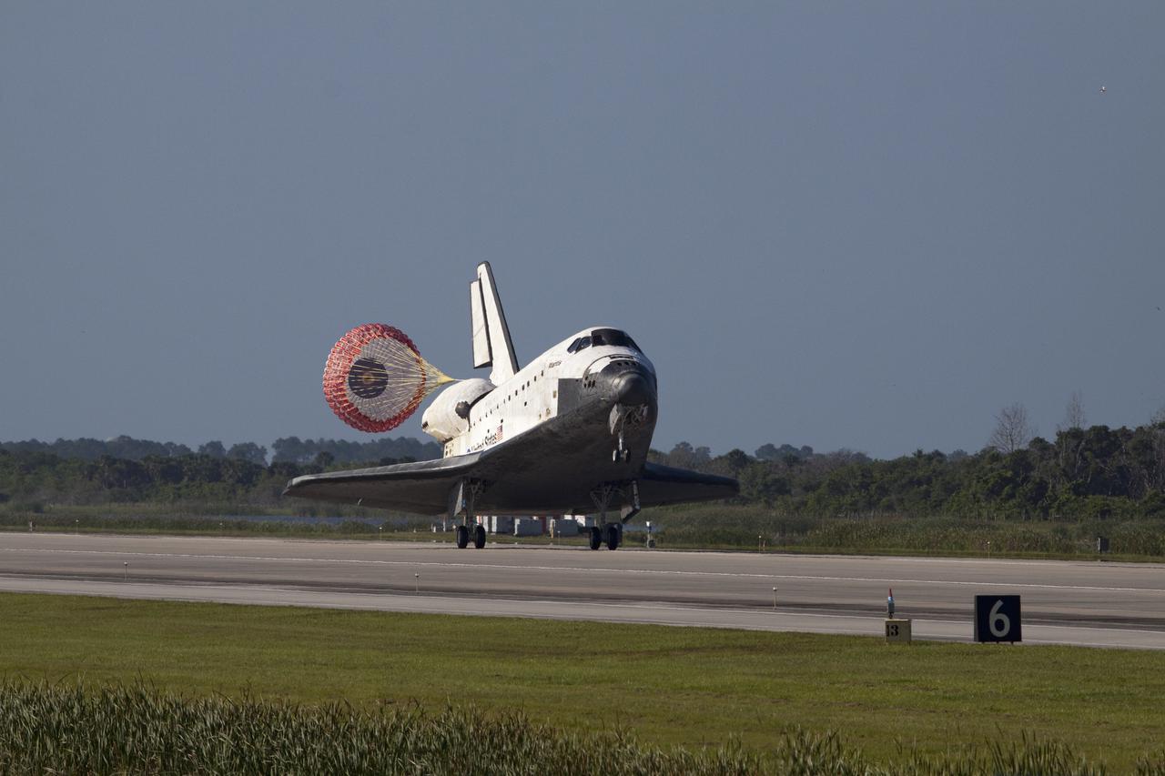 CAPE CANAVERAL, Fla. - With its drag chute unfurled, space shuttle Atlantis rolls down Runway 33 at the Shuttle Landing Facility at NASA's Kennedy Space Center in Florida. Landing was at 8:48 a.m. EDT, completing the 12-day STS-132 mission to the International Space Station.    The six-member STS-132 crew carried the Russian-built Mini Research Module-1 to the space station. STS-132 is the 34th shuttle mission to the station, the 132nd shuttle mission overall and the last planned flight for Atlantis. For information on the STS-132 mission and crew, visit www.nasa.gov_mission_pages_shuttle_shuttlemissions_sts132_index.html. Photo credit: NASA_Jack Pfaller
