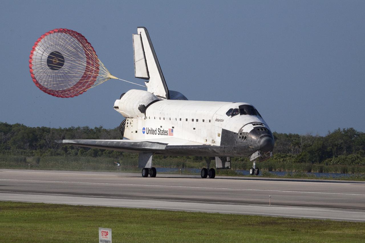 CAPE CANAVERAL, Fla. - With its drag chute unfurled, space shuttle Atlantis rolls down Runway 33 at the Shuttle Landing Facility at NASA's Kennedy Space Center in Florida. Landing was at 8:48 a.m. EDT, completing the 12-day STS-132 mission to the International Space Station.    The six-member STS-132 crew carried the Russian-built Mini Research Module-1 to the space station. STS-132 is the 34th shuttle mission to the station, the 132nd shuttle mission overall and the last planned flight for Atlantis. For information on the STS-132 mission and crew, visit www.nasa.gov_mission_pages_shuttle_shuttlemissions_sts132_index.html. Photo credit: NASA_Jack Pfaller