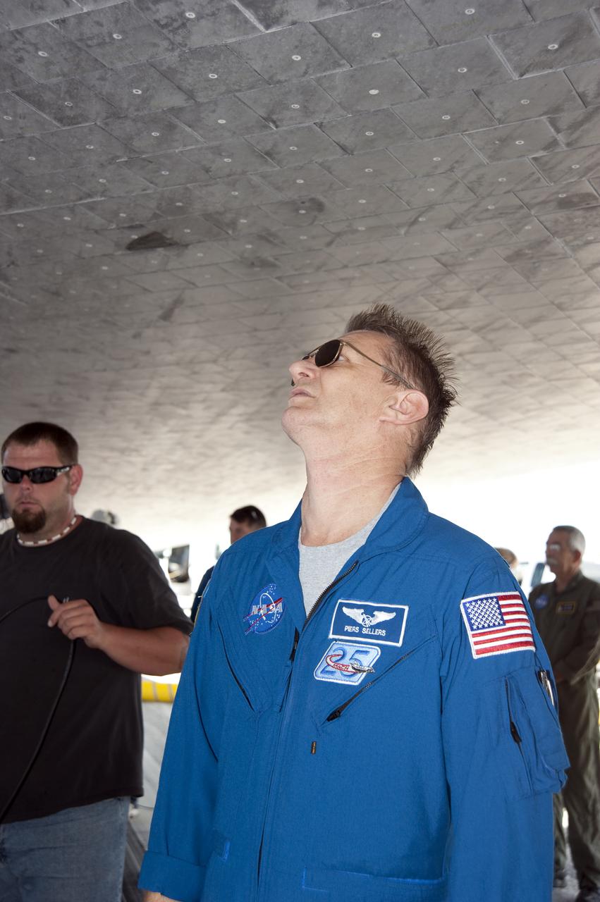 CAPE CANAVERAL, Fla. - STS-132 Mission Specialist Piers Sellers takes an up-close look at the underside of space shuttle Atlantis after its picture-perfect touchdown at the Shuttle Landing Facility at NASA's Kennedy Space Center in Florida. The six-member STS-132 crew carried the Russian-built Mini Research Module-1 to the space station. STS-132 is the 34th shuttle mission to the station, the 132nd shuttle mission overall and the last planned flight for Atlantis. For information on the STS-132 mission and crew, visit www.nasa.gov_mission_pages_shuttle_shuttlemissions_sts132_index.html. Photo credit: NASA_Kim Shiflett