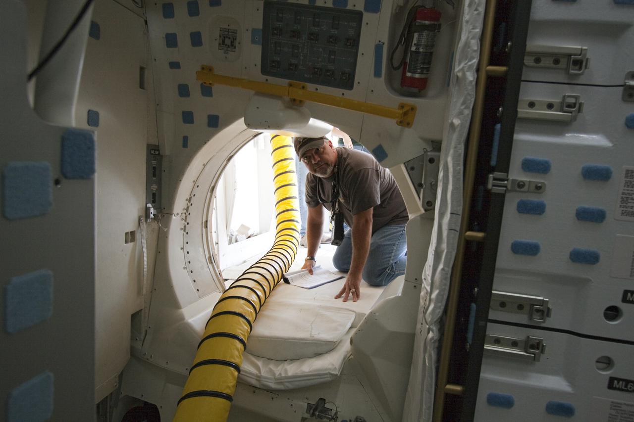 CAPE CANAVERAL, Fla. - Inside space shuttle Atlantis' crew compartment, a United Space Alliance employee works through an extensive checklist to 'safe' the vehicle for towback from the Shuttle Landing Facility runway to Orbiter Processing Facility-1 at NASA's Kennedy Space Center in Florida. After every shuttle landing, about 150 trained workers assist the crew out and then make the vehicle safe for towing atop a large diesel-driven tractor. Atlantis touched down on Runway 33 after 12 days in space, completing the 4.8-million mile STS-132 mission to the International Space Station. Inside the processing facility, Atlantis will be prepared for the unlikely event it is needed as a rescue spacecraft for the final planned shuttle flight, Endeavour's STS-134 mission. For more information, visit www.nasa.gov_shuttle. Photo credit: NASA_Troy Cryder