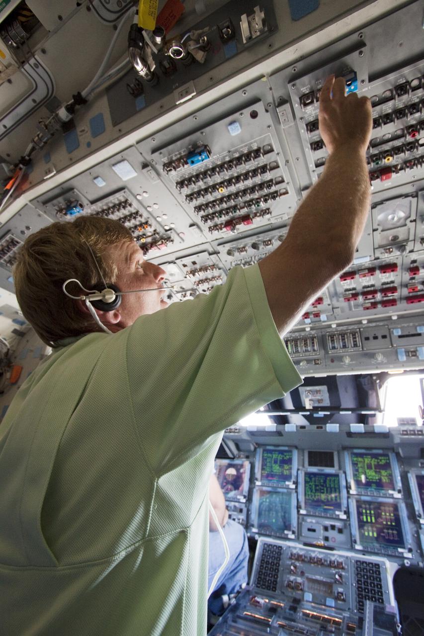 CAPE CANAVERAL, Fla. - Inside space shuttle Atlantis' crew compartment, a United Space Alliance employee begins to power down the vehicle for towback from the Shuttle Landing Facility runway to Orbiter Processing Facility-1 at NASA's Kennedy Space Center in Florida. After every shuttle landing, about 150 trained workers assist the crew out and then make the vehicle safe for towing atop a large diesel-driven tractor. Atlantis touched down on Runway 33 after 12 days in space, completing the 4.8-million mile STS-132 mission to the International Space Station. Inside the processing facility, Atlantis will be prepared for the unlikely event it is needed as a rescue spacecraft for the final planned shuttle flight, Endeavour's STS-134 mission. For more information, visit www.nasa.gov_shuttle. Photo credit: NASA_Troy Cryder