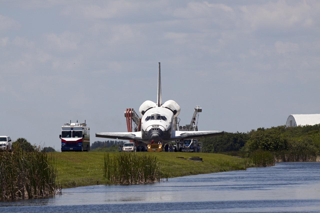 CAPE CANAVERAL, Fla. - At NASA's Kennedy Space Center in Florida, space shuttle Atlantis makes its slow trek from the Shuttle Landing Facility to Orbiter Processing Facility-1. Atlantis touched down on Runway 33 after 12 days in space, completing the 4.8-million mile STS-132 mission to the International Space Station. The six-member STS-132 crew carried the Russian-built Mini Research Module-1 to the space station. STS-132 is the 34th shuttle mission to the station, the 132nd shuttle mission overall and the last planned flight for Atlantis. For information on the STS-132 mission and crew, visit www.nasa.gov_mission_pages_shuttle_shuttlemissions_sts132_index.html. Photo credit: NASA_Jack Pfaller