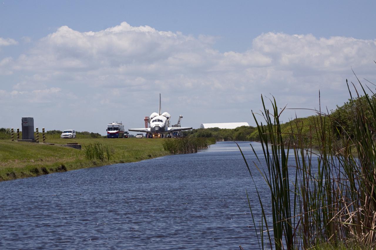 CAPE CANAVERAL, Fla. - At NASA's Kennedy Space Center in Florida, space shuttle Atlantis makes its slow trek from the Shuttle Landing Facility to Orbiter Processing Facility-1. Atlantis touched down on Runway 33 after 12 days in space, completing the 4.8-million mile STS-132 mission to the International Space Station. The six-member STS-132 crew carried the Russian-built Mini Research Module-1 to the space station. STS-132 is the 34th shuttle mission to the station, the 132nd shuttle mission overall and the last planned flight for Atlantis. For information on the STS-132 mission and crew, visit www.nasa.gov_mission_pages_shuttle_shuttlemissions_sts132_index.html. Photo credit: NASA_Jack Pfaller