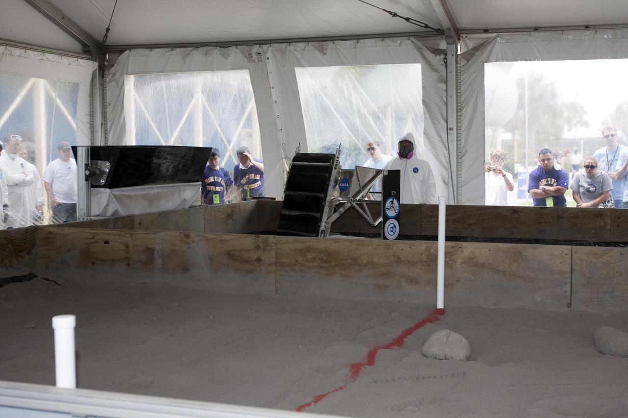 CAPE CANAVERAL, Fla. - Inside the 'Lunarena' at the Kennedy Space Center Visitor Complex's Astronaut Hall of Fame, university students are ready to maneuver their remote controlled or autonomous excavators, called lunabots, in about 60 tons of ultra-fine simulated lunar soil, called BP-1. Twenty-two teams from around the country are competing in NASA's first Lunabotics Mining Competition. The competition is an Exploration Systems Mission Directorate project managed by Kennedy's Education Division. The purpose is to engage and retain students in science, technology, engineering and mathematics, or STEM, fields. It also provides a competitive environment that could result in innovative ideas and solutions for NASA's future excavation of the moon. Photo credit: NASA_Dimitri Gerondidakis