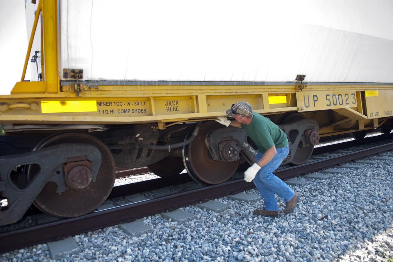 CAPE CANAVERAL, Fla. - At the Jay Jay Rail Yard in Titusville, Fla., a NASA Railroad mechanic checks out the brakes on a Union Pacific rail car carrying one of the last space shuttle solid rocket booster segments. The NASA train will transport the segments on the last leg of their journey into NASA's Kennedy Space Center. Six cars transported the segments along the Florida East Coast Railway, which began at the ATK solid rocket booster plant in Promontory, Utah.   The booster segments will be used for shuttle Atlantis on what currently is planned as the 'launch on need,' or potential rescue mission for the final shuttle flight, Endeavour's STS-134 mission.  For information, visit www.nasa.gov_shuttle. Photo credit: NASA_Jim Grossman