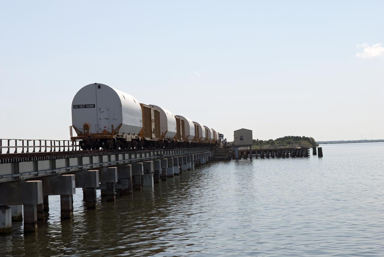 CAPE CANAVERAL, Fla. - The NASA Railroad train transports the last space shuttle solid rocket booster segments over the Indian River on the 13-mile trip from the Jay Jay Rail Yard in Titusville, Fla., to NASA's Kennedy Space Center. Six cars transported the segments along the Florida East Coast Railway, which began at the ATK solid rocket booster plant in Promontory, Utah.  The booster segments will be used for shuttle Atlantis on what currently is planned as the 'launch on need,' or potential rescue mission for the final shuttle flight, Endeavour's STS-134 mission.  For information, visit www.nasa.gov_shuttle. Photo credit: NASA_Jim Grossmann
