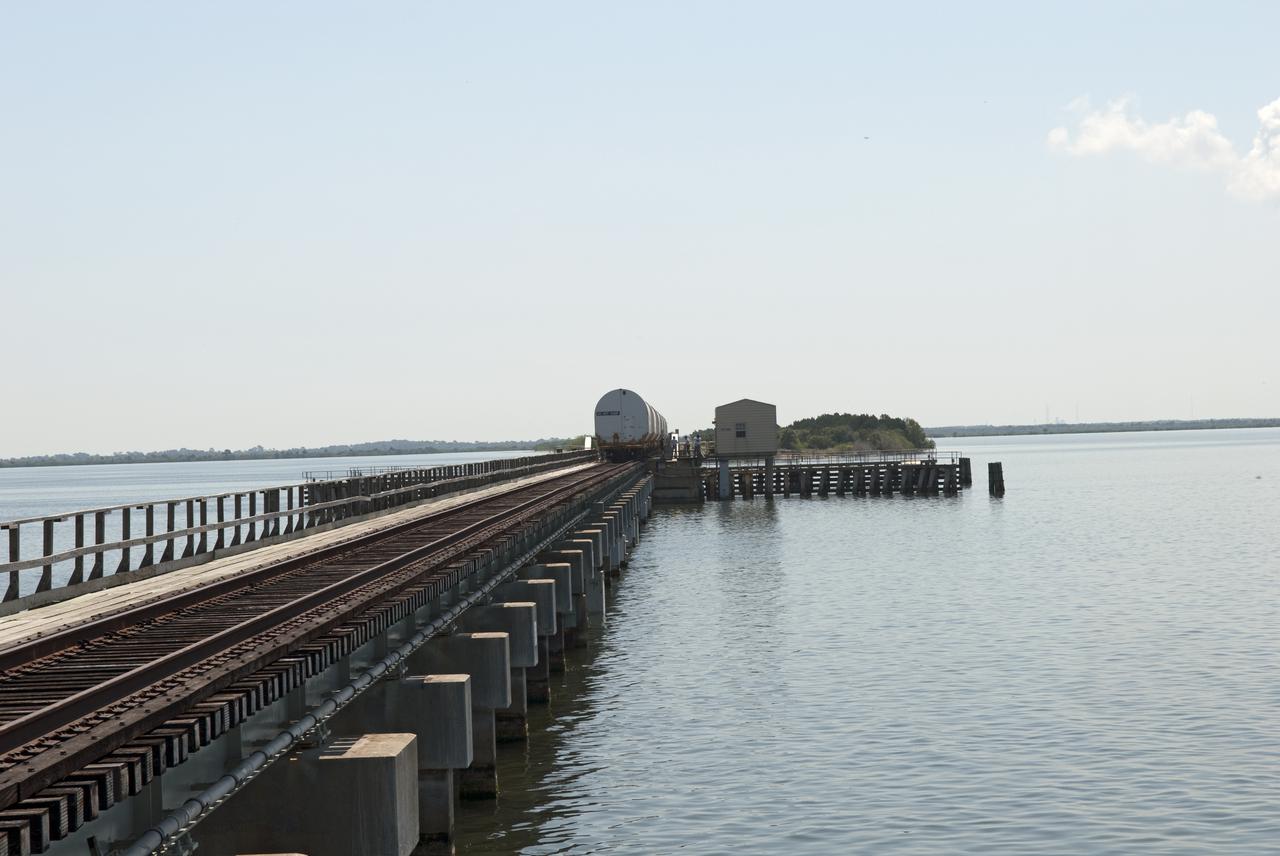CAPE CANAVERAL, Fla. - The NASA Railroad train transports the last space shuttle solid rocket booster segments over the Indian River on the 13-mile trip from the Jay Jay Rail Yard in Titusville, Fla., to NASA's Kennedy Space Center. Six cars transported the segments along the Florida East Coast Railway, which began at the ATK solid rocket booster plant in Promontory, Utah.  The booster segments will be used for shuttle Atlantis on what currently is planned as the 'launch on need,' or potential rescue mission for the final shuttle flight, Endeavour's STS-134 mission.  For information, visit www.nasa.gov_shuttle. Photo credit: NASA_Jim Grossmann