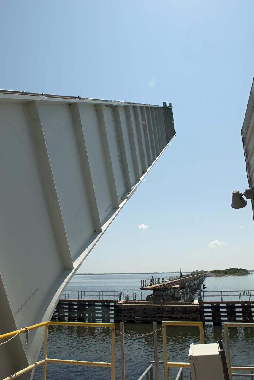 CAPE CANAVERAL, Fla. - The NASA Railroad draw bridge over the Indian River begins to close for the train carrying the last space shuttle solid rocket booster segments to NASA's Kennedy Space Center. Six cars transported the segments along the Florida East Coast Railway, which began at the ATK solid rocket booster plant in Promontory, Utah.  The booster segments will be used for shuttle Atlantis on what currently is planned as the 'launch on need,' or potential rescue mission for the final shuttle flight, Endeavour's STS-134 mission.  For information, visit www.nasa.gov_shuttle. Photo credit: NASA_Jim Grossmann