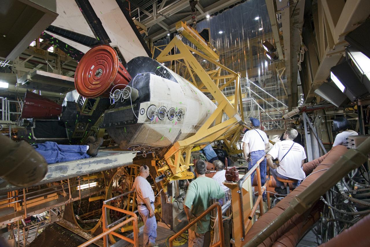 CAPE CANAVERAL, Fla. – Inside Orbiter Processing Facility-3 at Kennedy Space Center in Florida, United Space Alliance technicians prepare to remove the right-hand orbital maneuvering system, or OMS, pod from Discovery. Removal of the OMS pods is part of the orbiter processing activities to prepare Discovery for its next launch, the STS-133 mission. The STS-133 mission to the International Space Station is targeted for launch in the fall of 2010. Discovery’s six-person crew will take important spare parts to the International Space Station along with the Express Logistics Carrier 4. Photo credit: NASA_Jack Pfaller