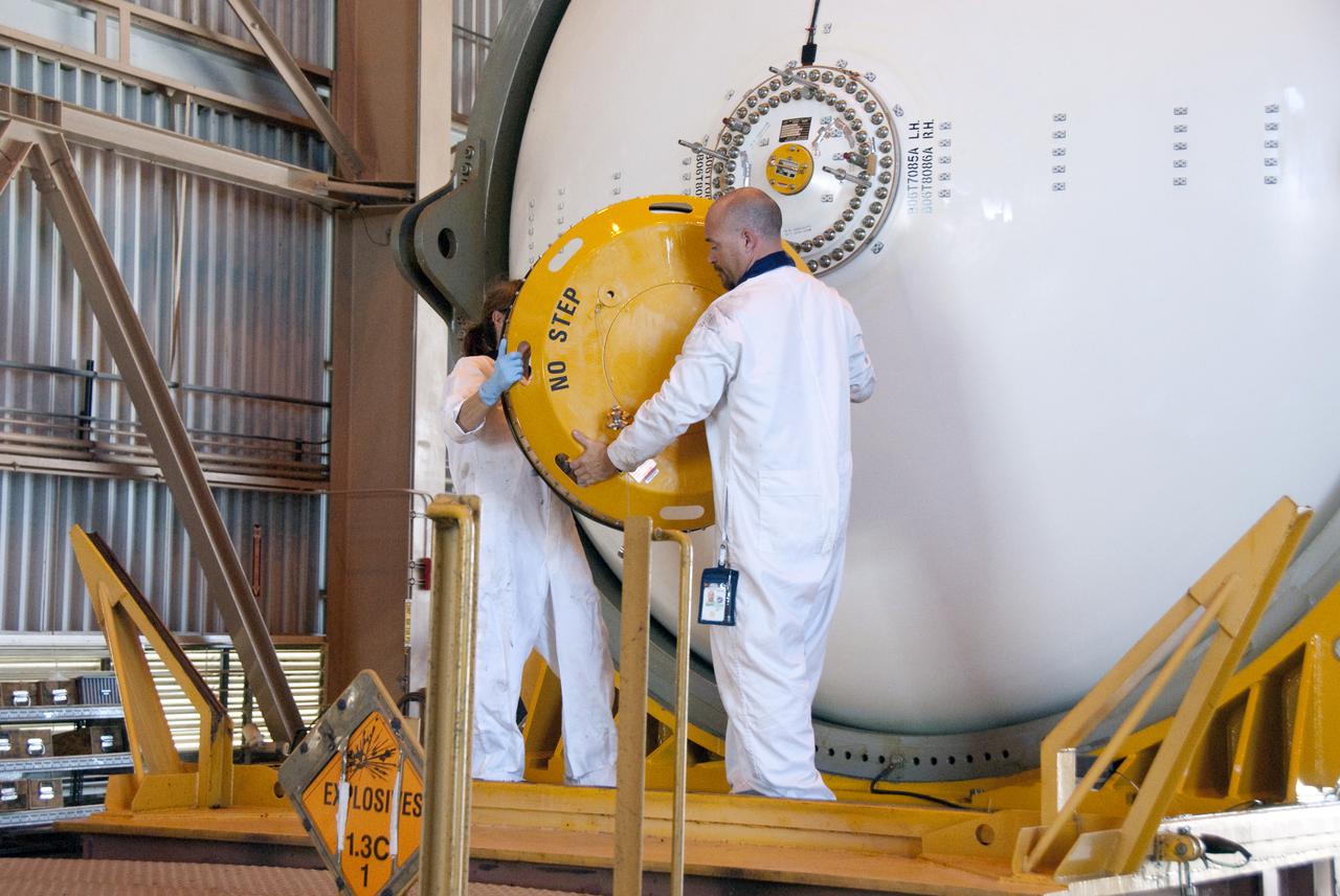 CAPE CANAVERAL, Fla. -- In the Rotation, Processing and Surge Facility, or RSPF, at NASA's Kennedy Space Center in Florida, workers perform the propellant grain inspection of the final solid rocket booster segments, which is a required safety analysis. The booster segments were manufactured at the ATK solid rocket booster plant in Promontory, Utah, and traveled to Kennedy along the Florida East Coast Railway.  The booster segments will be stacked and then mated to space shuttle Atlantis and its external fuel tank in the Vehicle Assembly Building. The segments will be used for what currently is planned as the 'launch on need,' or potential rescue mission for the final shuttle flight, Endeavour's STS-134 mission. For information, visit www.nasa.gov_shuttle. Photo credit: NASA_Cory Huston