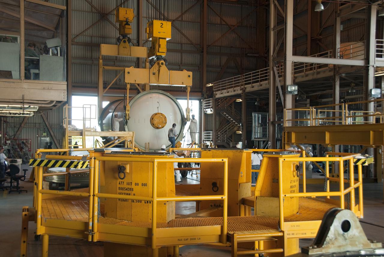 CAPE CANAVERAL, Fla. -- At NASA's Kennedy Space Center in Florida, workers prepare to lift and stack the final solid rocket booster segment in the Rotation, Processing and Surge Facility.    The segments will be used for space shuttle  Atlantis on what currently is planned as the 'launch on need,' or potential rescue mission for the final shuttle flight, Endeavour's STS-134 mission. For information, visit www.nasa.gov_shuttle. Photo credit: NASA_Cory Huston