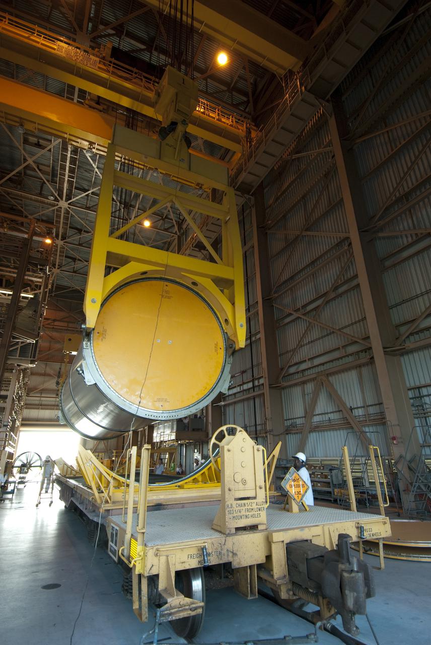 CAPE CANAVERAL, Fla. -- Twin cranes hoist the first solid rocket booster segment from a rail car in the Rotation, Processing and Surge Facility at NASA's Kennedy Space Center in Florida. It will then be rotated into a vertical position and placed a work stand.   The segments will be used for space shuttle  Atlantis on what currently is planned as the 'launch on need,' or potential rescue mission for the final shuttle flight, Endeavour's STS-134 mission. For information, visit www.nasa.gov_shuttle. Photo credit: NASA_Cory Huston
