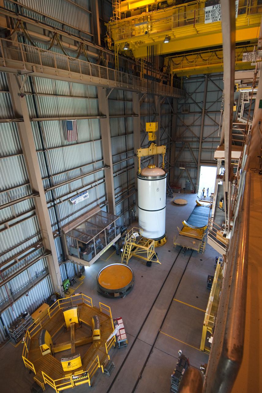 CAPE CANAVERAL, Fla. -- This overhead view in the Rotation, Processing and Surge Facility at NASA's Kennedy Space Center in Florida, shows the booster segment seated in the work stand and the transportation and storage pallet where it will be moved.   The segments will be used for space shuttle  Atlantis on what currently is planned as the 'launch on need,' or potential rescue mission for the final shuttle flight, Endeavour's STS-134 mission. For information, visit www.nasa.gov_shuttle. Photo credit: NASA_Cory Huston