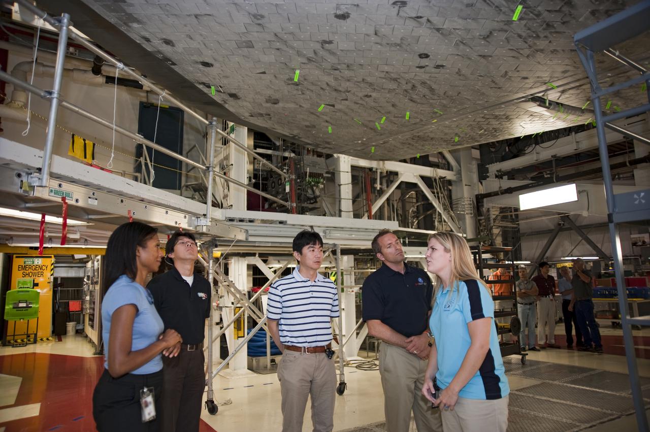 CAPE CANAVERAL, Fla. --- At NASA's Kennedy Space Center in Florida, the Class of 2009 Astronaut Candidates, also called ASCANs, tour Orbiter Processing Facility-1. Inside the facility, space shuttle Atlantis is being processed for the 'launch on need,' or potential rescue mission for the final scheduled shuttle flight, Endeavour's STS-134 mission. Sarah Schilling, Atlantis' processing engineer, right, was on hand to answer questions about the vehicle. The new astronaut candidates for NASA are Serena M. Aunon, Jeanette J. Epps, Air Force Maj. Jack D. Fischer, Air Force Lt. Col. Michael S. Hopkins, Kjell N. Lindgren, Kathleen 'Kate' Rubins, Navy Cmdr. Scott D. Tingle, Army Lt. Col. Mark T. Vande, and Navy Lt. Cmdr. Gregory R. 'Reid' Wiseman. The new astronaut candidates for the Japan Aerospace Exploration Agency, or JAXA, are Norishige Kanai, Takuya Onishi and Kimiya Yui. The new astronaut candidates for the Canadian Space Agency, or CSA, are Jeremy Hansen and David Saint-Jacques. Photo Credit: NASA_Kim Shiflett