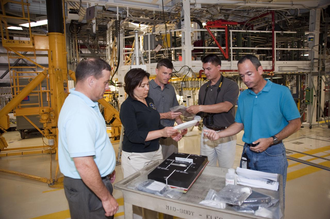 CAPE CANAVERAL, Fla. --- At NASA's Kennedy Space Center in Florida, the Class of 2009 Astronaut Candidates, also called ASCANs, check out heat shield tiles in Orbiter Processing Facility-1. Inside the facility, space shuttle Atlantis is being processed for the 'launch on need,' or potential rescue mission for the final scheduled shuttle flight, Endeavour's STS-134 mission.    The new astronaut candidates for NASA are Serena M. Aunon, Jeanette J. Epps, Air Force Maj. Jack D. Fischer, Air Force Lt. Col. Michael S. Hopkins, Kjell N. Lindgren, Kathleen 'Kate' Rubins, Navy Cmdr. Scott D. Tingle, Army Lt. Col. Mark T. Vande, and Navy Lt. Cmdr. Gregory R. 'Reid' Wiseman. The new astronaut candidates for the Japan Aerospace Exploration Agency, or JAXA, are Norishige Kanai, Takuya Onishi and Kimiya Yui. The new astronaut candidates for the Canadian Space Agency, or CSA, are Jeremy Hansen and David Saint-Jacques. Photo Credit: NASA_Kim Shiflett