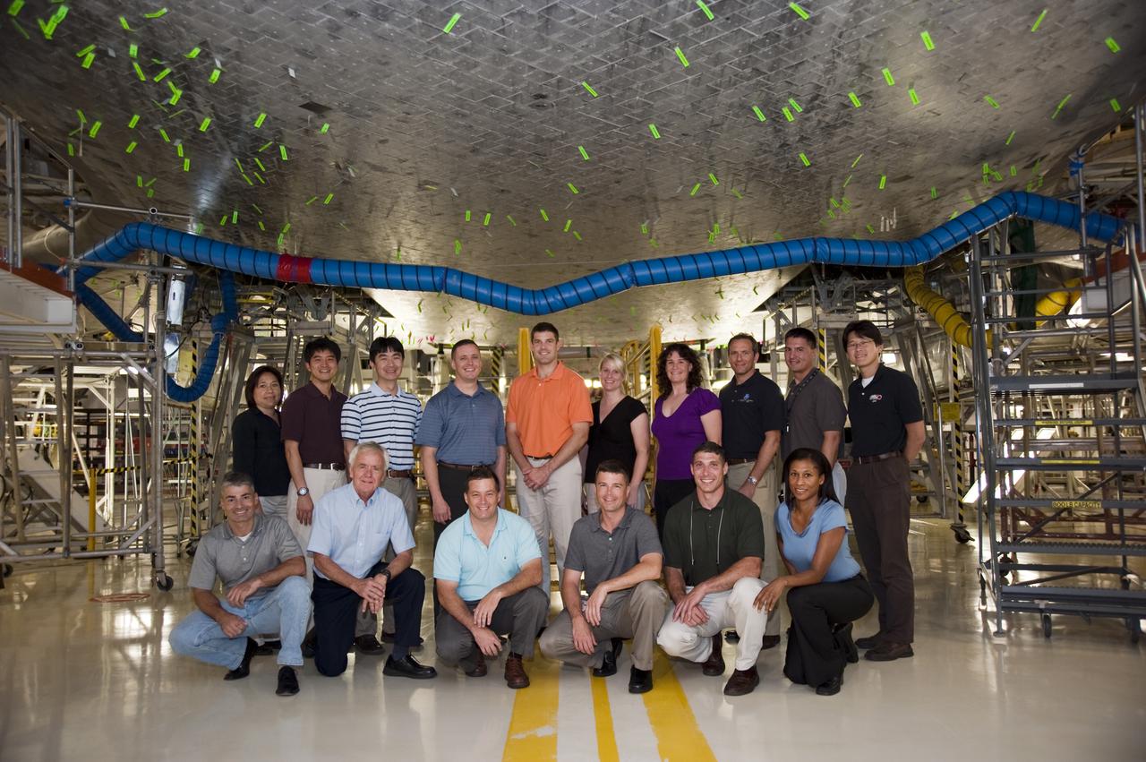 CAPE CANAVERAL, Fla. --- At NASA's Kennedy Space Center in Florida, the Class of 2009 Astronaut Candidates, also called ASCANs, take a picture under space shuttle Atlantis in Orbiter Processing Facility-1. Standing, from left, are Astronaut Office Training Specialist Debbie Trainor, JAXA's Takuya Onishi and Kimiya Yui, NASA's Air Force Maj. Jack D. Fischer, CSA's Jeremy Hansen, NASA's Kathleen 'Kate' Rubins and Serena M. Aunon, CSA's David Saint-Jacques, NASA's Kjell N. Lindgren, and JAXA's Norishige Kanai. Kneeling, from left, are NASA's Army Lt. Col. Mark T. Vande, Chief of the Astronaut Candidate Program Duane Ross, Navy Cmdr. Scott D. Tingle, Navy Lt. Cmdr. Gregory R. 'Reid' Wiseman, Air Force Lt. Col. Michael S. Hopkins, and Jeanette J. Epps. Photo Credit: NASA_Kim Shiflett