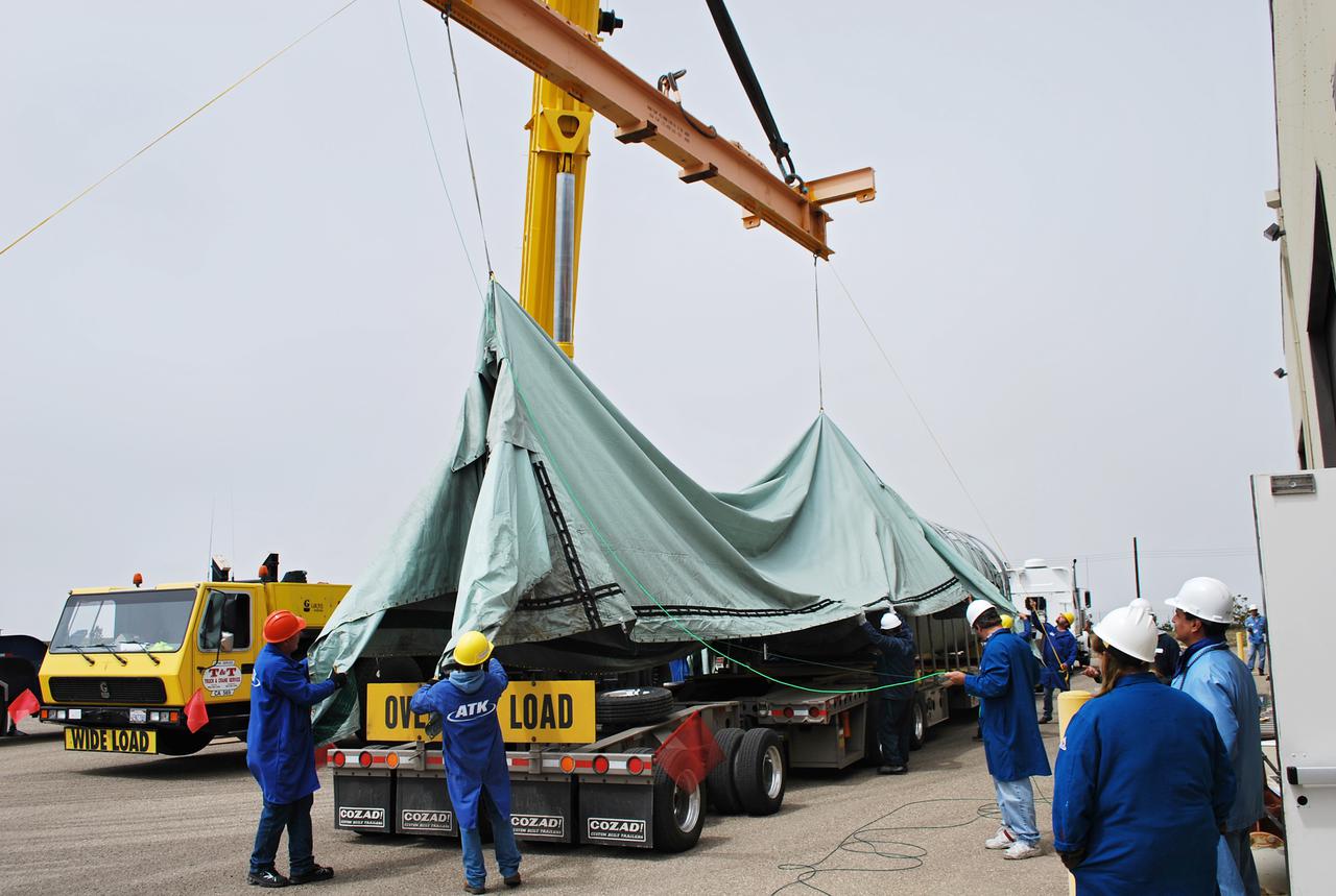VANDENBERG AIR FORCE BASE, Calif. --  At Vandenberg Air Force Base in California, workers remove the shipping canvas off the Stage 0 motor for the Taurus XL launch vehicle. The motor will help carry NASA's Glory satellite into low Earth orbit.   Glory is scheduled to launch in November from Vandenberg's Launch Pad SLC 576-E. Once Glory reaches orbit, it will collect data on the properties of aerosols and black carbon. It also will help scientists understand how the sun's irradiance affects Earth's climate.  Photo credit: NASA_Randy Beaudoin, VAFB