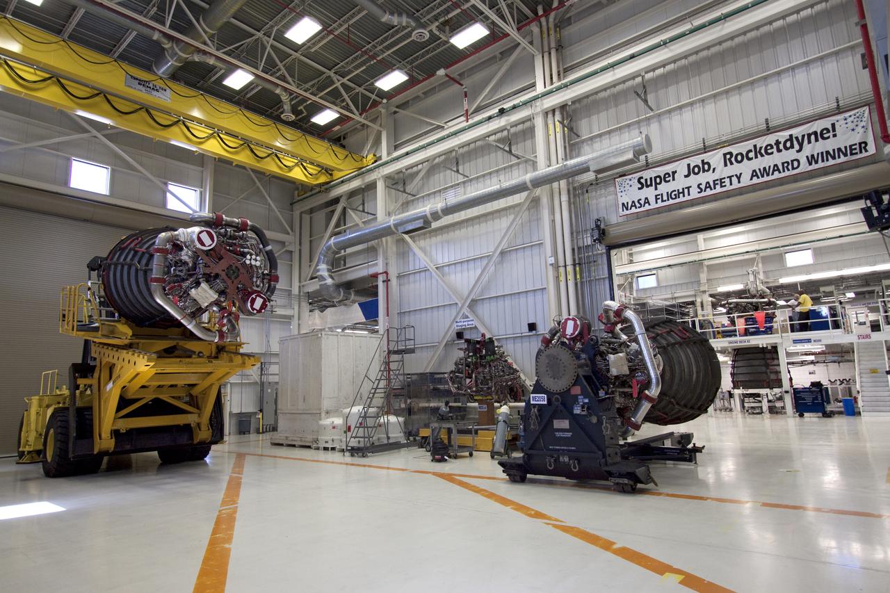 CAPE CANAVERAL, Fla. -- In the Space Shuttle Main Engine Processing Facility at NASA's Kennedy Space Center in Florida, a space shuttle main engine is secured on a Hyster forklift, left, and ready for its move to Orbiter Processing Facility-3. Three main engines, weighing 7,000 pounds each, will be installed in space shuttle Discovery for the STS-133 mission to the International Space Station. Discovery and its STS-133 crew are targeted to deliver the Express Logistics Carrier-4 filled with external payloads and experiments, as well as critical spare components to the station later this year. Photo credit: NASA_Jack Pfaller