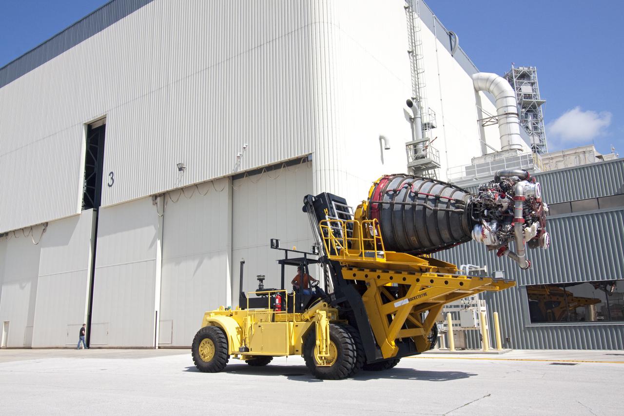CAPE CANAVERAL, Fla. -- At NASA's Kennedy Space Center in Florida, a space shuttle main engine secured on a Hyster forklift moves from the Space Shuttle Main Engine Processing Facility to Orbiter Processing Facility-3. Three main engines, weighing 7,000 pounds each, will be installed in space shuttle Discovery for the STS-133 mission to the International Space Station. Discovery and its STS-133 crew are targeted to deliver the Express Logistics Carrier-4 filled with external payloads and experiments, as well as critical spare components to the station later this year. Photo credit: NASA_Jack Pfaller