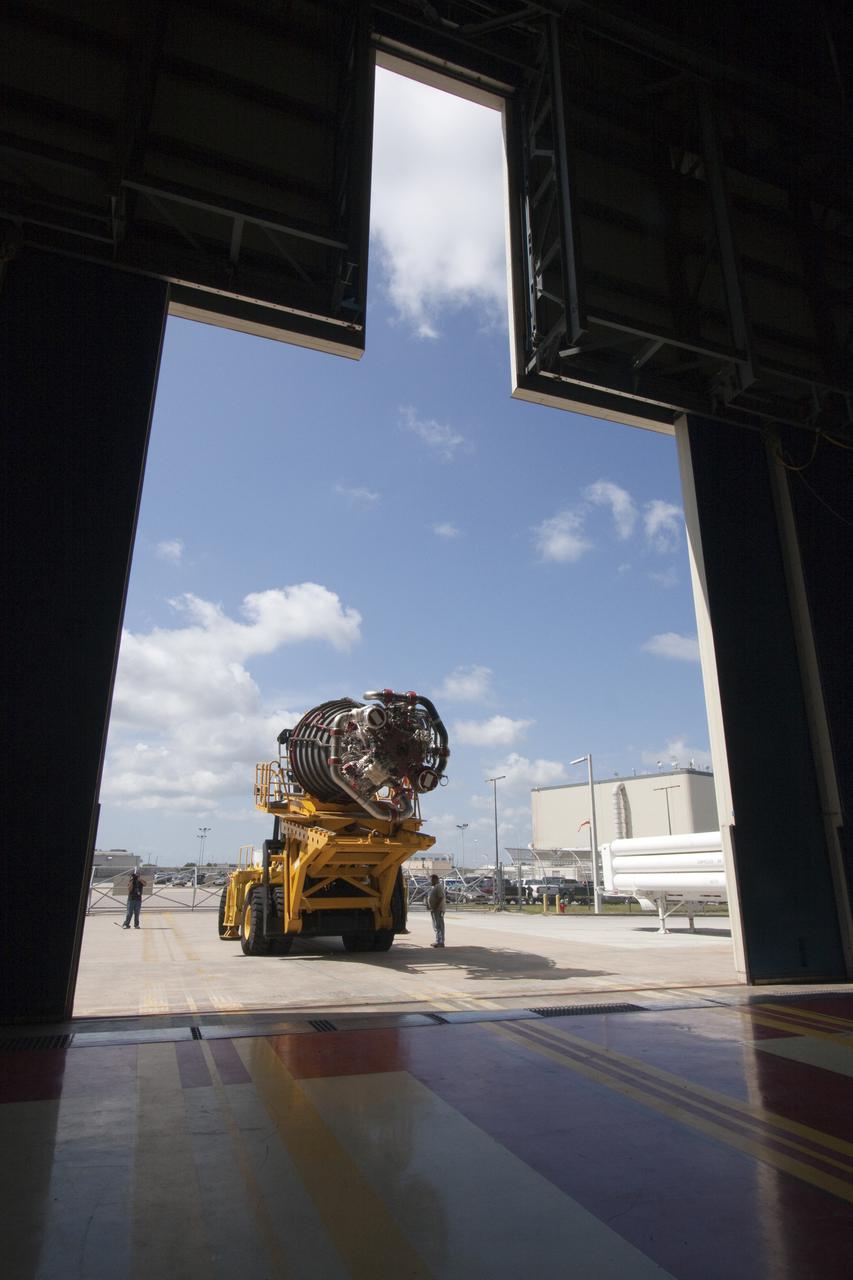 CAPE CANAVERAL, Fla. -- At NASA's Kennedy Space Center in Florida, a space shuttle main engine secured on a Hyster forklift enters Orbiter Processing Facility-3. Three main engines, weighing 7,000 pounds each, will be installed in space shuttle Discovery for the STS-133 mission to the International Space Station. Engines are inspected and maintained in the nearby Space Shuttle Main Engine Processing Facility before installation.   Discovery and its STS-133 crew are targeted to deliver the Express Logistics Carrier-4 filled with external payloads and experiments, as well as critical spare components to the station later this year. Photo credit: NASA_Jack Pfaller