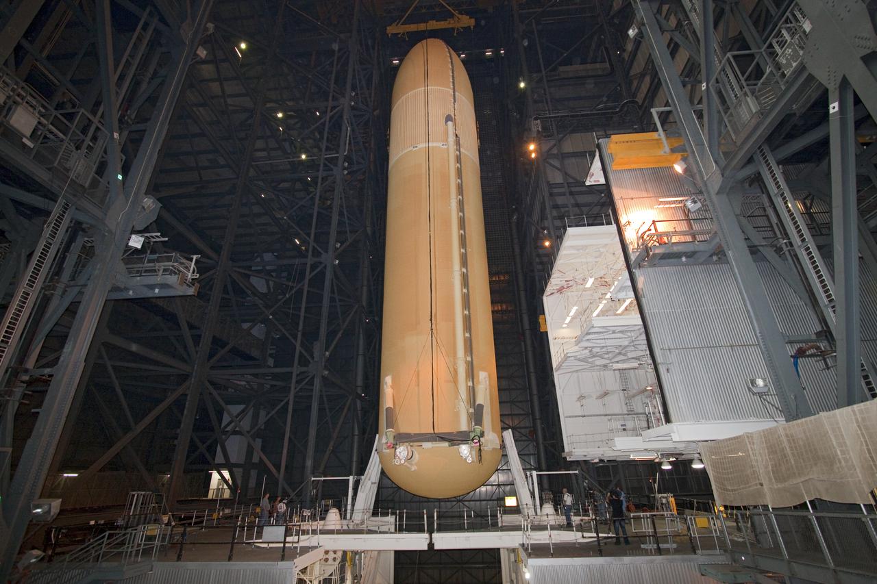 CAPE CANAVERAL, Fla. -- In the Vehicle Assembly Building at NASA's Kennedy Space Center in Florida, external fuel tank ET-137 for space shuttle Discovery's STS-133 mission is lowered into position to be attached to the twin solid rocket boosters. Discovery will deliver NASA's Permanent Multi-purpose Module, or PMM, the Express Logistics Carrier 4, and critical spare parts to the International Space Station. Launch is targeted for fall 2010. Photo credit: NASA_Jack Pfaller