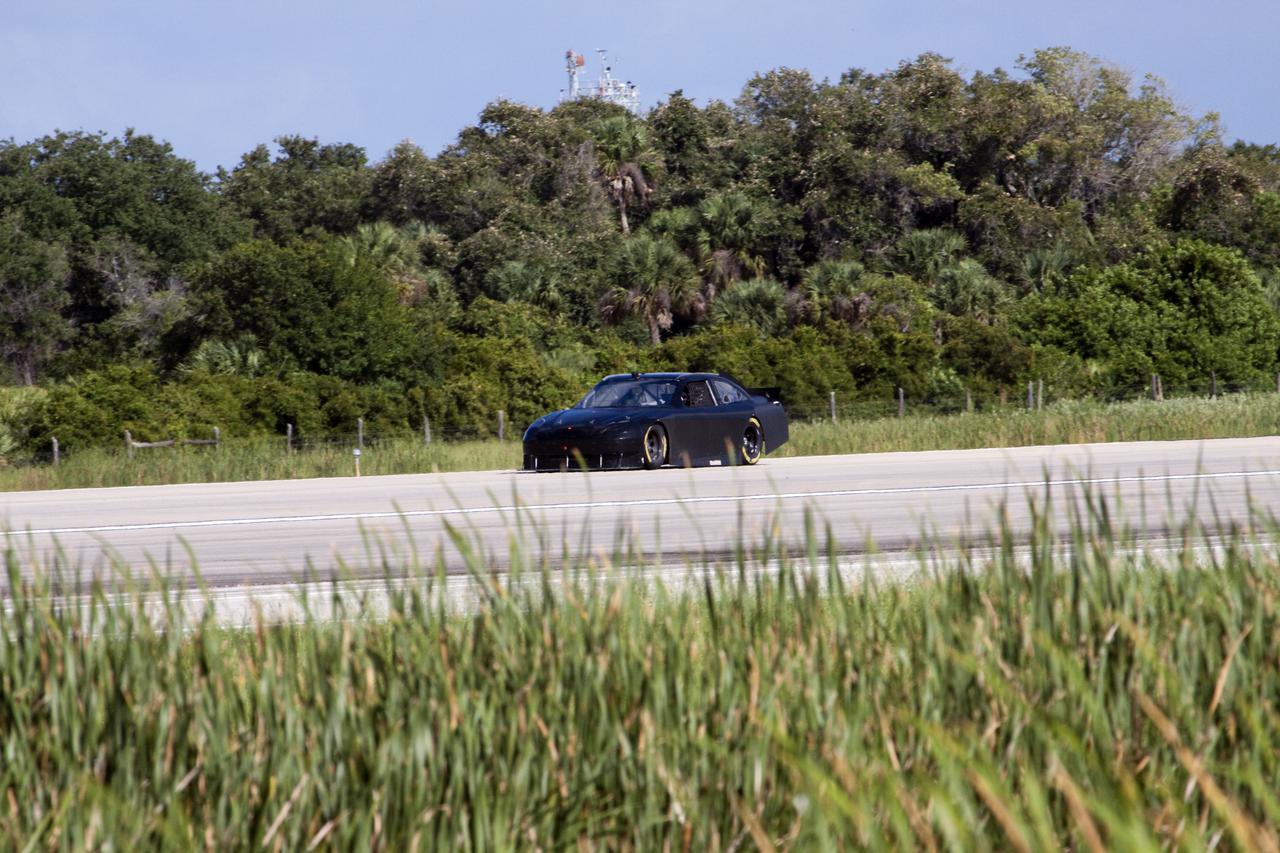 CAPE CANAVERAL, Fla. – At NASA's Kennedy Space Center in Florida, NASCAR racer Matt DiBenedetto drives an instrument-laden Toyota down the three-mile-long Shuttle Landing Facility runway. The operation was part Joe Gibbs Racing's program to test aerodynamic and real-world capabilities on one of the flattest surfaces in the world. Racing teams have been using the runway for testing since 2008. Joe Gibbs Racing signed a Space Act Agreement with NASA in May to use the facility's runway. Photo Credit: NASA_Jack Pfaller