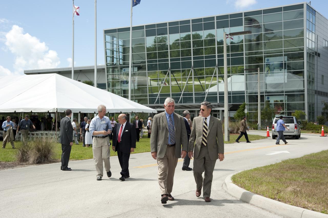 CAPE CANAVERAL, Fla. – At NASA's Kennedy Space Center in Florida, Kennedy Center Director Bob Cabana, right, walks with Program Manager for Strategic Partnerships at Kennedy Jim Ball to the ground breaking site of Exploration Park outside of the Space Life Sciences Laboratory, or SLSL. To their left, are The Pizzuti Companies Chairman and CEO Ron Pizzuti and Patrick Peterson, a space reporter with Florida Today.  Exploration Park is designed to be a strategically located complex, adjacent to the SLSL, for servicing diverse tenants and uses that will engage in activities to support space-related activities of NASA, other government agencies and the U.S. commercial space industry, as well as bring new aerospace work to the Space Coast. The SLSL will be the anchor facility for the park, which is expected to open its first new facility in early 2012. Photo Credit: NASA_Kim Shiflett