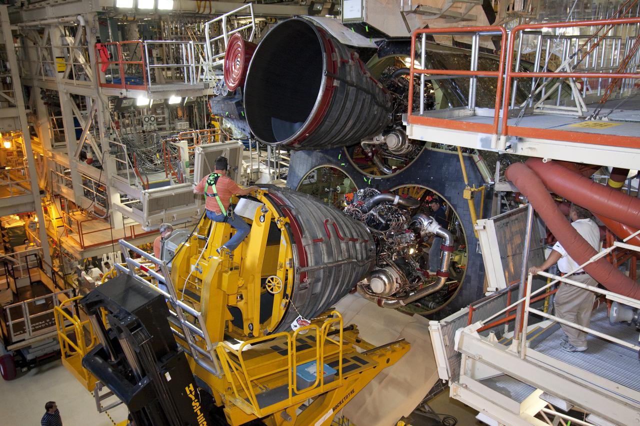CAPE CANAVERAL, Fla. -- In Orbiter Processing Facility-3 at NASA's Kennedy Space Center in Florida, space shuttle main engine No. 3 is installed in shuttle Discovery. The engine was removed to give technicians time to replace a suspect turbopump in main engine No. 1, which encountered an issue during torque testing.  Discovery and its STS-133 crew are targeted to deliver the Express Logistics Carrier-4 filled with external payloads and experiments, as well as critical spare components to the International Space Station later this year. Photo credit: NASA_Jack Pfaller